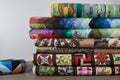 Quilts stacked on white wall background