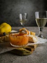 Quince fruit jam, white wine in glasses, cheese on wooden board on gray background Royalty Free Stock Photo