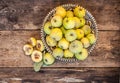 Quince fruits on a wooden background. Harvest of autumn fruits. Yellow tart hard fruit. Cut quince with leaf. Terry