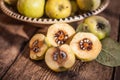 Quince fruits on a wooden background. Harvest of autumn fruits. Yellow tart hard fruit. Cut apple-quince with leaf