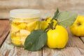 Quince, sugar candied quince in a glass jar on a wooden background Royalty Free Stock Photo