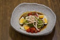 quinoa avocado slice, shredded chicken, boiled egg silce, tomatos slice on white and black ceramic bowl on wooden table background Royalty Free Stock Photo