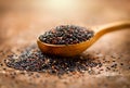 Quinoa. Black grains in a wooden spoon. Dieting concept. Seeds of Black quinoa - Chenopodium quinoa