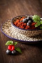 Quinoa blueberries and raspberries on a plate with black backgro Royalty Free Stock Photo