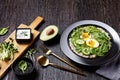 Quinoa bowl with greens, avocado and boiled egg
