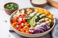 quinoa bowl with roasted vegetables and dressing on side