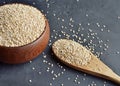 Quinoa in a brown wooden bowl and spoon on dark stone background. Dry uncooked cereal grains, cooking ingredient Royalty Free Stock Photo