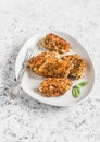 Quinoa crusted chicken on a light background.