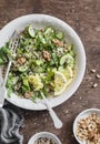 Quinoa and greens veggies salad for a spring detox. Salad with quinoa, cucumbers, avocado, arugula, ginger, flax seeds and nuts on