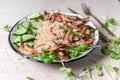 Quinoa with grilled prawns or shrimps, cucumber and micro greens on the marble background side view. Royalty Free Stock Photo