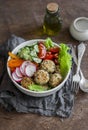 Quinoa meatballs and vegetable salad. Buddha bowl on a wooden table, top view. Healthy, diet, vegetarian food concept.