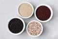 Quinoa mixed. Red black white quinoa seeds in bowls on gray stone background Royalty Free Stock Photo