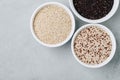 Quinoa mixed. Red black white quinoa seeds in bowls on gray stone background Royalty Free Stock Photo