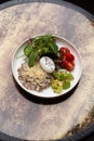 Quinoa porridge breakfast with oatmeal, poached egg Royalty Free Stock Photo