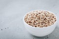 Quinoa. Red white brown quinoa seeds in bowl. Mixed raw quinoa seeds on gray stone background Royalty Free Stock Photo