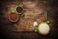 Quinoa set. Black, white and red raw quinoa grains in bowls, groats assorted, wooden rustic kitchen table, top view and copy space