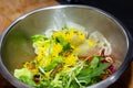 Quinoa Tabouleh salad in a bowl sitting on a wooden table