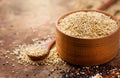 Quinoa. White quinoa grains in a wooden bowl. Healthy food. Seeds of white, red and black quinoa - Chenopodium qu