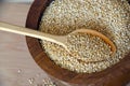 Quinoa in a wooden spoon on the table. Healthy eating. Vegan food concept background