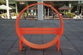 Quirky bright orange circular street bench. 2