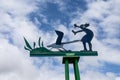 Quirky metal sculpture of lady being attacked by a goose on metal stand at the quayside in Fremantle, Australia