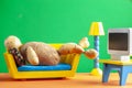 A quirky metaphorical concept image showing a potato man lying on a couch in a living room setting Royalty Free Stock Photo