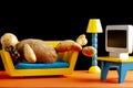 A quirky metaphorical concept image showing a potato man lying on a couch in a living room setting Royalty Free Stock Photo