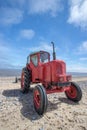 Quirky red diesel beach tractor. Vintage little red tractor Royalty Free Stock Photo