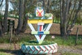 Quirky rural letterbox set in small garden inside old tractor tyre