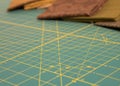 Quit rotary cutting mat with brown fabric in background