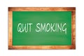 QUIT SMOKING text written on green school board