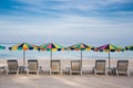 Quite beach with umbrellas and beach chairs and clear blue sky. Royalty Free Stock Photo