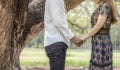 Quite moments together. Beautiful young couple holding hands while standing in the park, Love concept, decision making Royalty Free Stock Photo