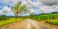 Quite road among green hills landscape, Mauritius. Panorama Royalty Free Stock Photo