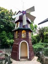 a quite unique miniature pinwheel house in a playground