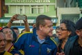 Quito, Ecuador - April 7, 2016: Closeup opposition leader Andres Paez surrounded by people, police and journalists