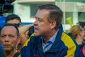 Quito, Ecuador - April 7, 2016: Closeup opposition leader Andres Paez surrounded by people, police and journalists