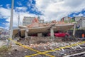Quito, Ecuador - April,17, 2016: House destroyed by Earthquake, with a red car caught under the destroyed construction, and heavy