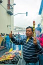 Quito, Ecuador - August 27, 2015: Man selling barbecue skewers in city streets during anti government mass Royalty Free Stock Photo
