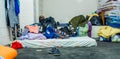 QUITO, ECUADOR, AUGUST 21, 2018: Pile of colorful clothes, bags and accessories in the ground of a room inside of a