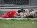 Quito, Ecuador, 1-2-2020: A homeless person in Quito, South America sleeping on collected matrasses with two dogs next to him Royalty Free Stock Photo