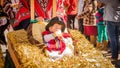 Quito, Ecuador - January 11, 2018: Close up of unidentified beautiful baby sitting at outdoors in a straw manger