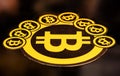 Quito, Ecuador - January 31, 2018: Indoor view of Golden Bitcoin logo. with small bitcoins logos around the big one Royalty Free Stock Photo