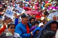 QUITO, ECUADOR - JULY 7, 2015: In the middle of thousand people, a big man with blue pull is praying, holding a jacket Royalty Free Stock Photo