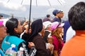 QUITO, ECUADOR - JULY 7, 2015: In the middle of thousand people a nun is praying under the sun, a police is behind her Royalty Free Stock Photo