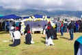 QUITO, ECUADOR - JULY 7, 2015: Nuns praying for pope Francisco, little altar in a tent with flowers and ballons in the