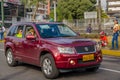 QUITO, ECUADOR - JULY 7, 2015: Police inside a wine color car, Suzuki big vitara. People outside