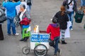 QUITO, ECUADOR - JULY 7, 2015: Woman from the back selling coconut juice, standing in the middle of the street