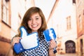 Quito, Ecuador - March 11, 2016: Woman holding with their hands a sticker facebook icon and a big like hand printed Royalty Free Stock Photo