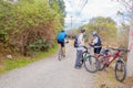 QUITO, ECUADOR - MARZO 23, 2015: Unidentified couple stop to arrange the equipment of one cyclist